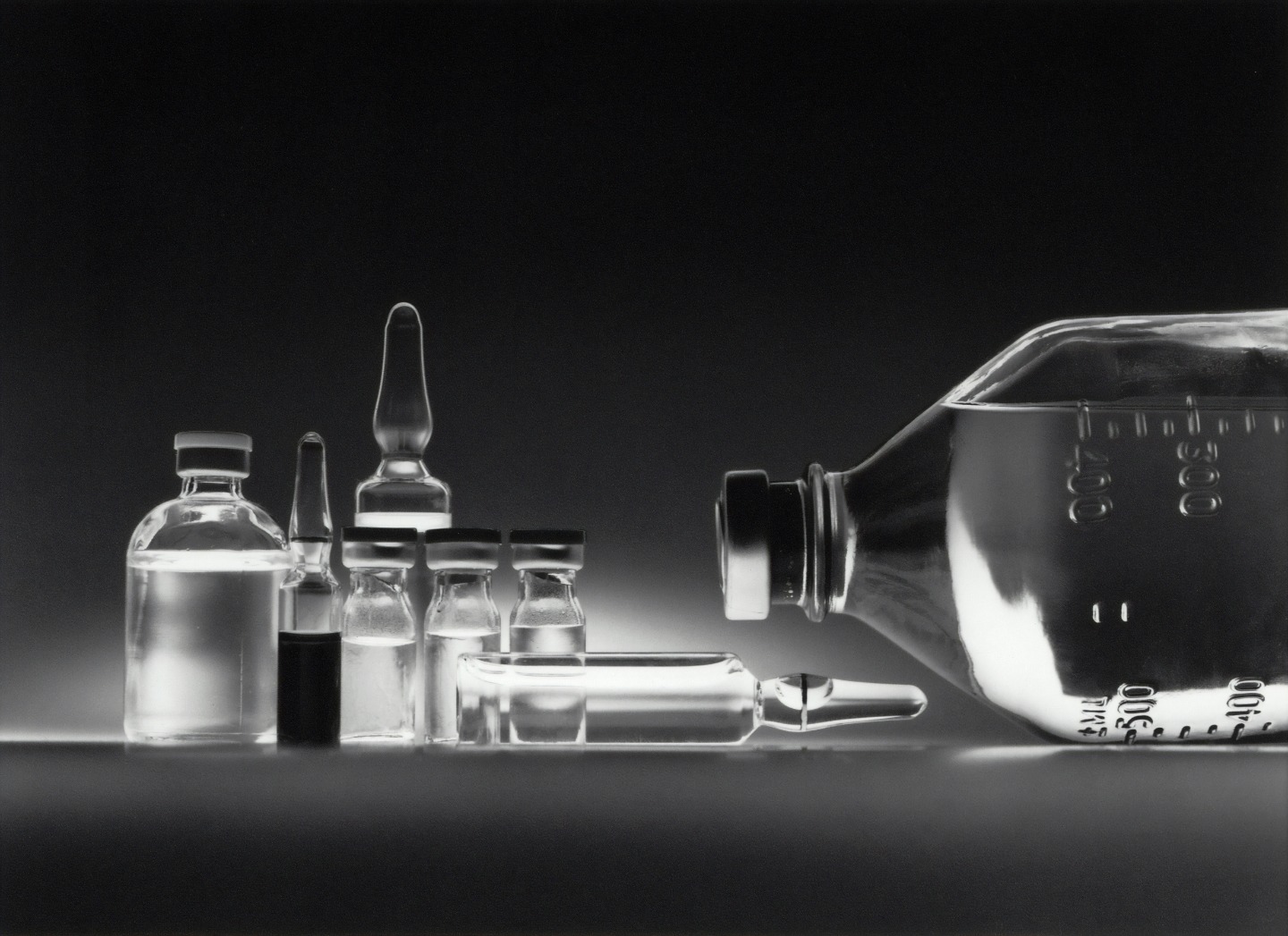 Black background with clear glass scientific containers